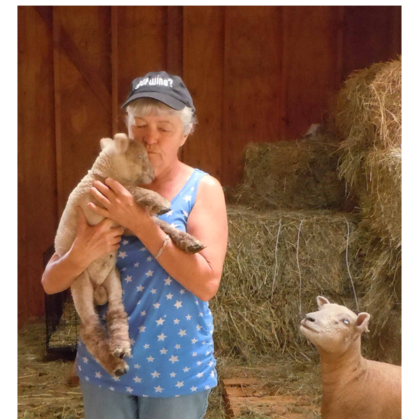 picture of woman holding lamb